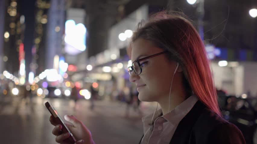 beautiful young caucasian women using smart phone in the city commuting to work. urban business people lifestyle background