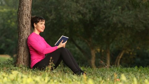 woman reading book in the nature, selective focus