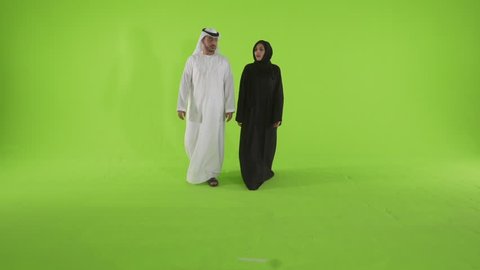 Emirati couple looking with curiosity. Dubai, UAE -- July 2015