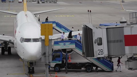 TURKEY - CIRCA JULY 2015 - Passengers exit airplane down stairs