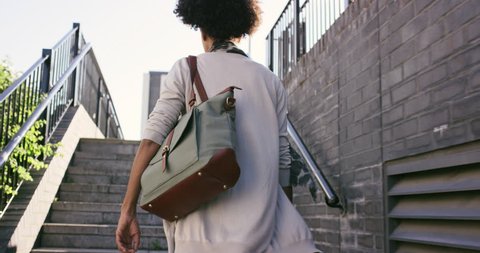 Beautiful Mixed race woman walking through urban city streets fashion lifestyle