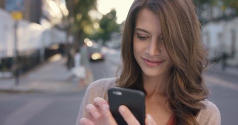 Beautiful woman using smart phone technology app in city streets living urban happy lifestyle
