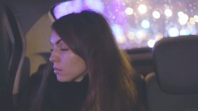 pensive girl riding in the car at night,lyrical mood, evening city in the window
