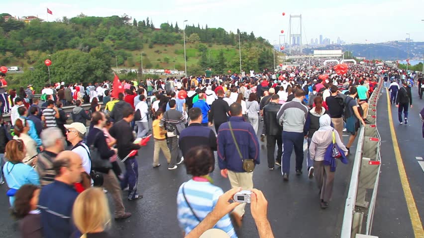 ISTANBUL - OCTOBER 17: Crowd of people walk from Asia to Europe through Bosporus