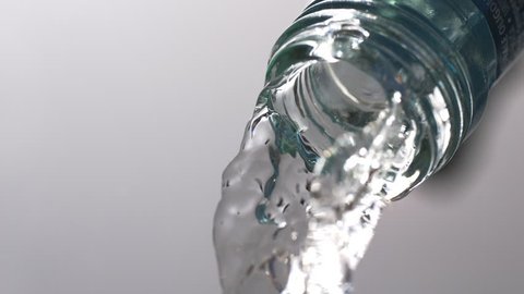 Water pouring from a bottle in super slow motion