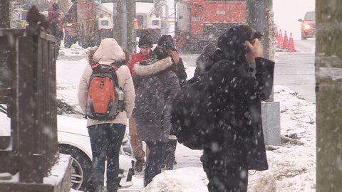 Waterloo, Ontario, Canada January 2014 Pedestrians slip fall on ice sidewalk in winter storm in Waterloo Canada
