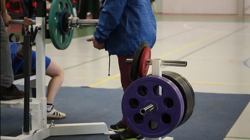 Competitions on powerlifting. Weightlifter bench presses of the barbell