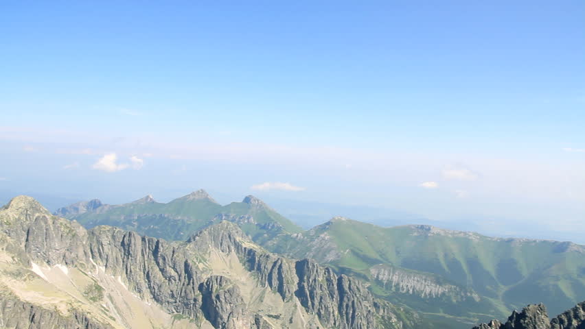 Young attractive woman looking in the mountains, camera stabilizer shot