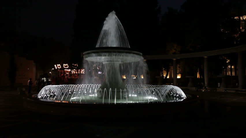 Beautiful colorful fountain at night in the city park 