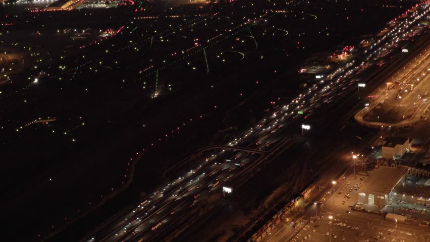 helicopter establishing shot of highway traffic jam at night