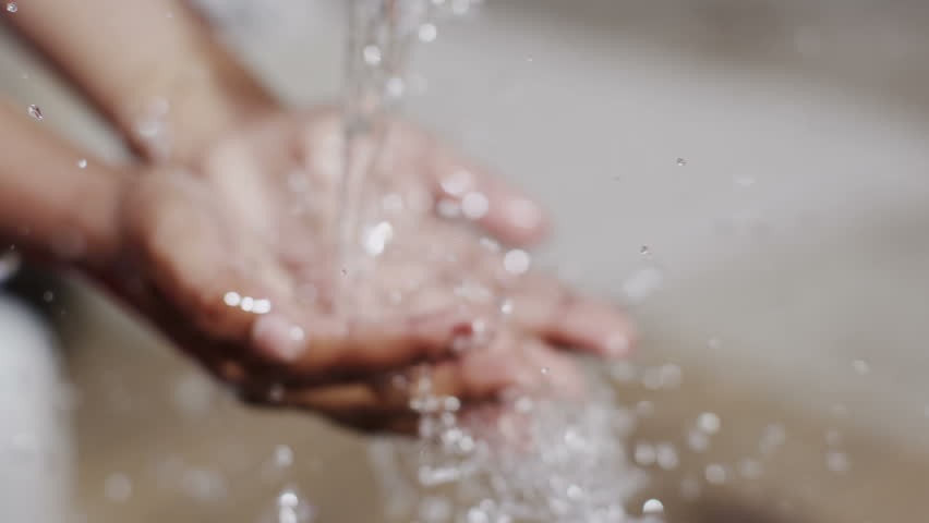 Happy villagers from a poor African community enjoy the sensation of clear, fresh water being poured over their hands. In slow motion. | Shutterstock HD Video #13955417