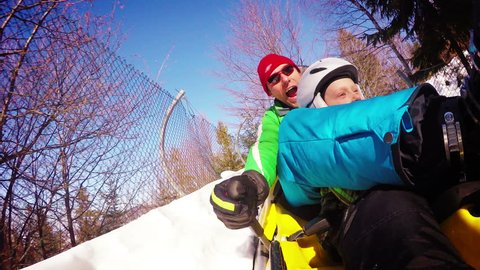 4k exciting multi-views footage: father and son enjoy bobsleighing