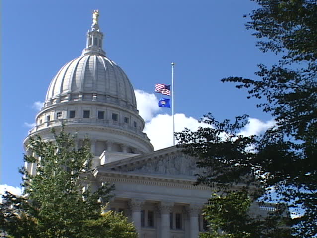 The United States Flag flies over the Capitol building in Madison, Wisconsin.