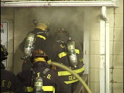 firemen enter burning house
