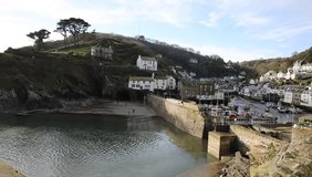 Polperro harbour Cornwall South West England UK smooth professional video pan with harbour buildings and village streets
