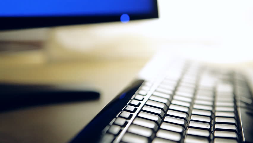 Hacker or programmer typing on computer keyboard. Man writing or programming code in dark room with back light. People working in office hands closeup. Technology concept. Shot with Canon 5DMkII