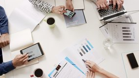 Top view Mixed race group of people office small business start up company planning creative meeting using digital tablets showing financial data and graphs - Powered by Shutterstock - Get 15% off with code: PIKWIZARD15