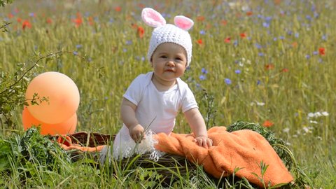 Easter bunny suit baby girl in basket outdoor