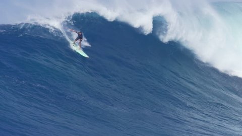 MAUI, HAWAII.  January, 15 2016: Surfers Ride Giant Ocean Waves Breaking at Jaws on North Shore in Hawaii. Professional Big Wave Surfing. Biggest Waves Ever Paddled