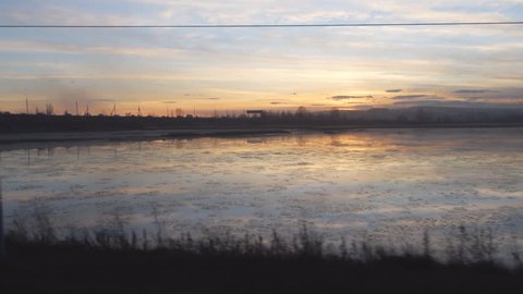 view from the window of a train on the Lake at sunset