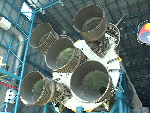 A large space shuttle stands in a building.
