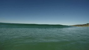 Ocean Wave breaking in clear water near the beach in California.  Filmed in High Definition Slow Motion Video.  