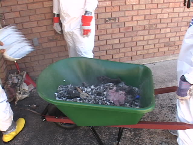 Workers clear up debris from a Hurricane Katrina damaged home in Biloxi, Mississippi.
