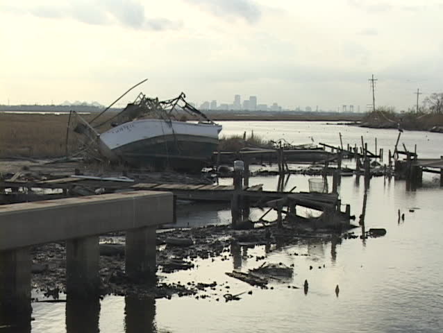 A fishing boat lays on its side on the shore after Hurricane Katrina.