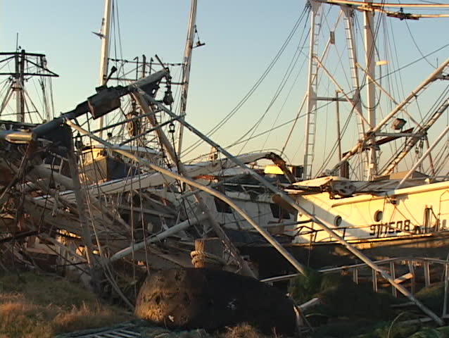 Fishing boats strewn about a harbor area show the destruction caused by Hurricane Katrina