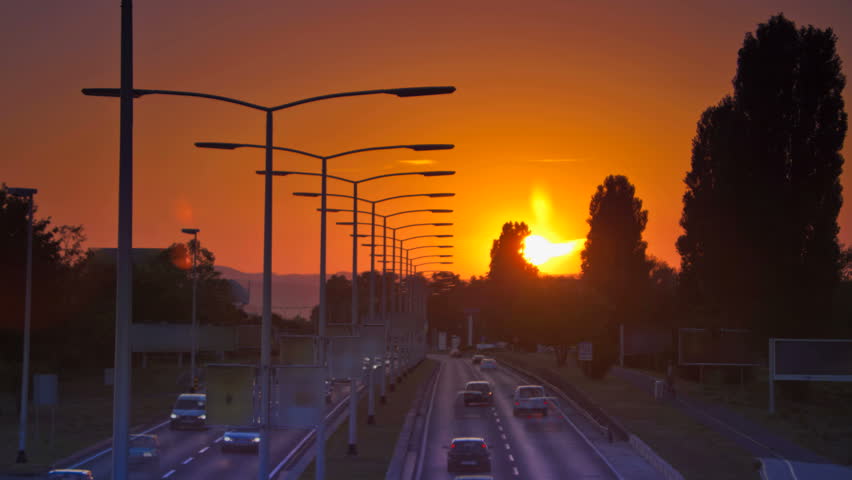 Cars Driving on highway at sunset time laps