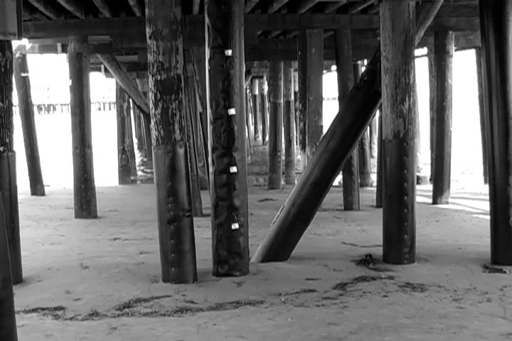 Woman appears under wharf.
