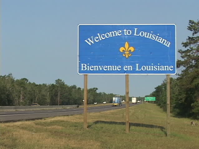 A highway sign greets visitors to Louisiana.
