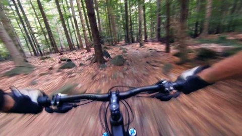 Speed riding downhill a MTB bike on rocky mountain. View from first person perspective POV. Gimbal stabilized view.