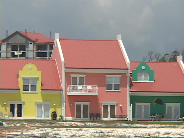 Multi-colored houses stand near a beach.