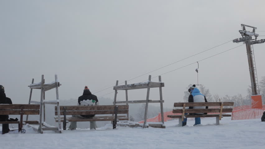 Snowboarders are preparing to descend