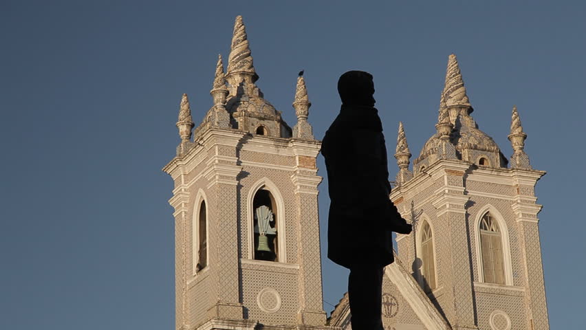 Silhouette of a statue and in the background vulture perched in the cathedral in Maceio, Alagoas, Brazil