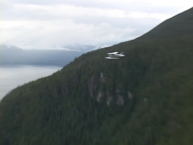 An aerial of a float plane flying over Alaska.