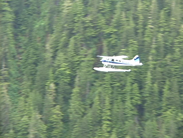 An aerial of a float plane flying over Alaska.