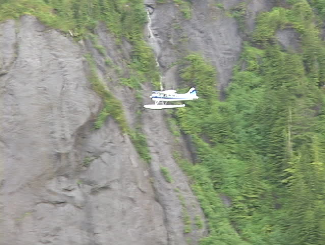 An aerial of a float plane flying over Alaska.