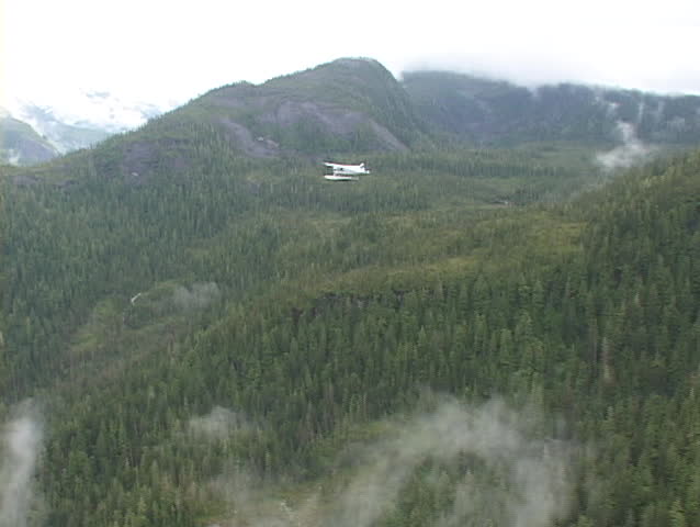 An aerial of a float plane flying over Alaska.
