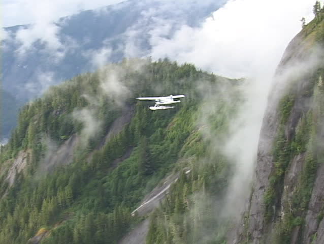 An aerial of a float plane flying over Alaska.