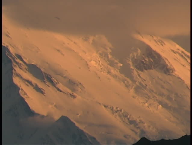 Mt. McKinley in Denali National Park, Alaska in clouds at sunset.