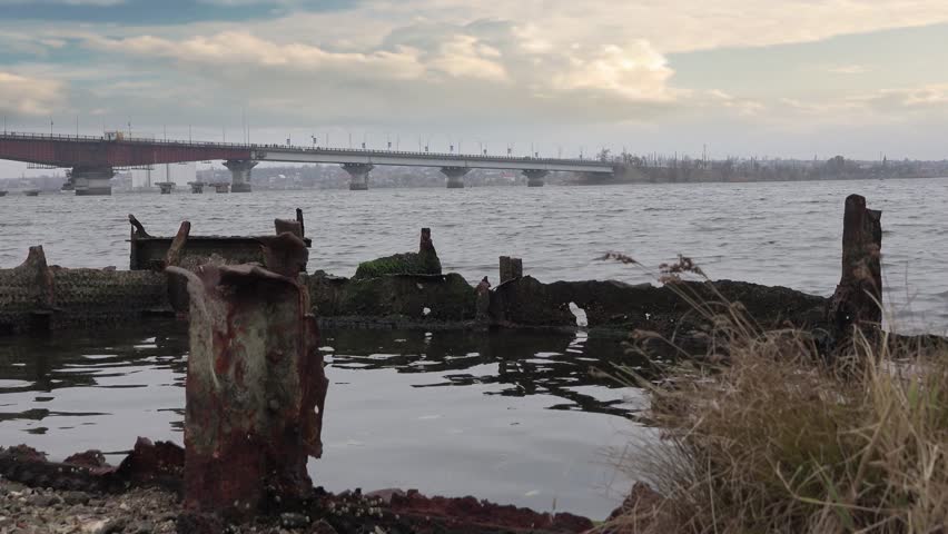 Rusty metal beams, frames, broken old ship on the river, Central Europe