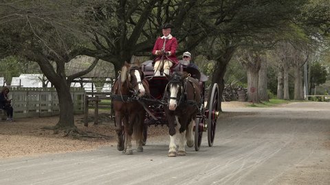 WILLIAMSBURG, VIRGINIA - CIRCA JUN 2015: Colonial Williamsburg Virginia historic horse carriage tourist ride. Education tourism demonstrating the early American life. Revolutionary War restoration.
