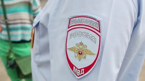 Shoulder of policemen with stripe and badge on chest. Text: Russian Interior Ministry, police - Powered by Shutterstock - Get 15% off with code: PIKWIZARD15