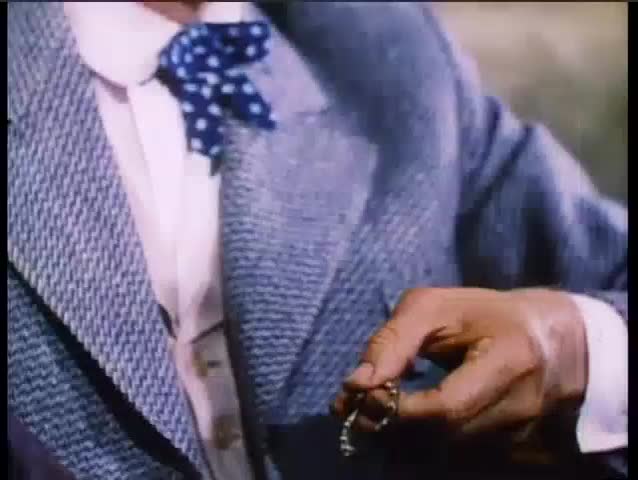 Nervous man rubbing good luck horseshoe on chain
