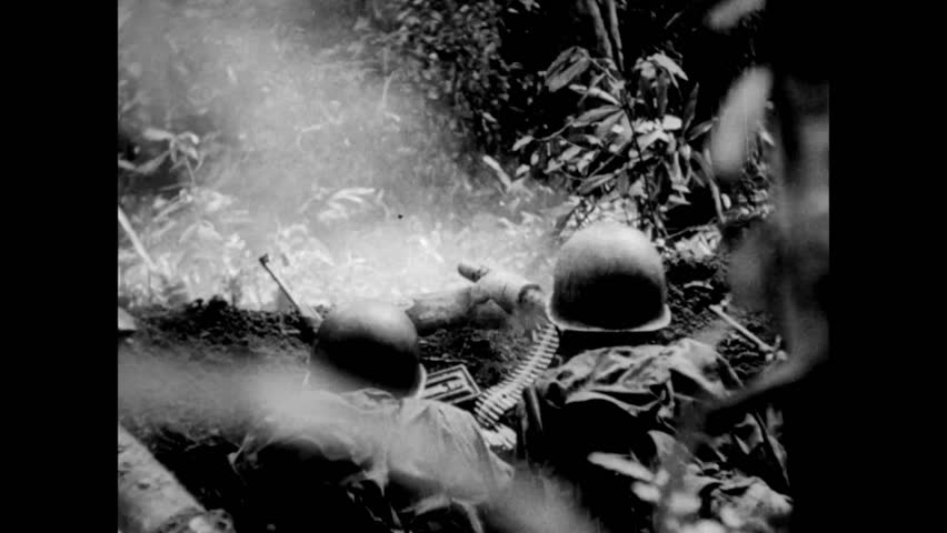 Rear view of soldiers firing machine guns, 1940s