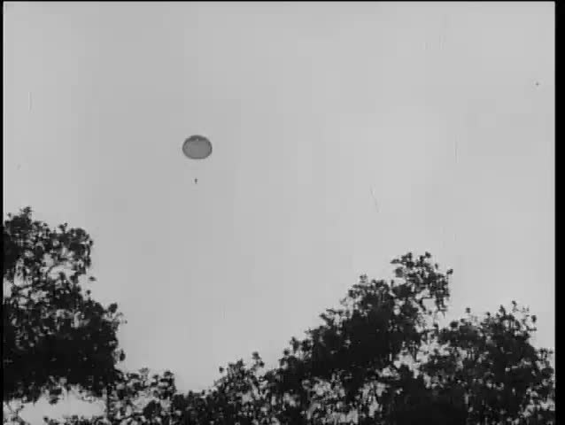 Low angle view of person parachuting against sky