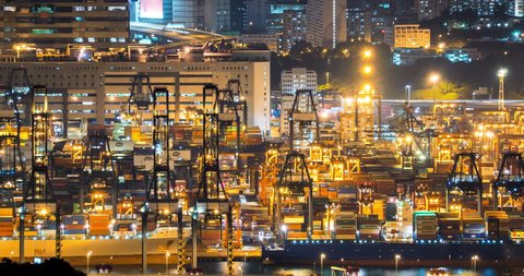 HONG KONG, CHINA - 17 JUL 2015: Busy container terminal of Hong Kong at night industrial background. Goods shipping worldwide from international port