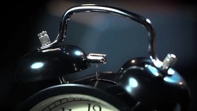 Super slow motion ancient desktop alarm clock on a black background macro - Powered by Shutterstock - Get 15% off with code: PIKWIZARD15